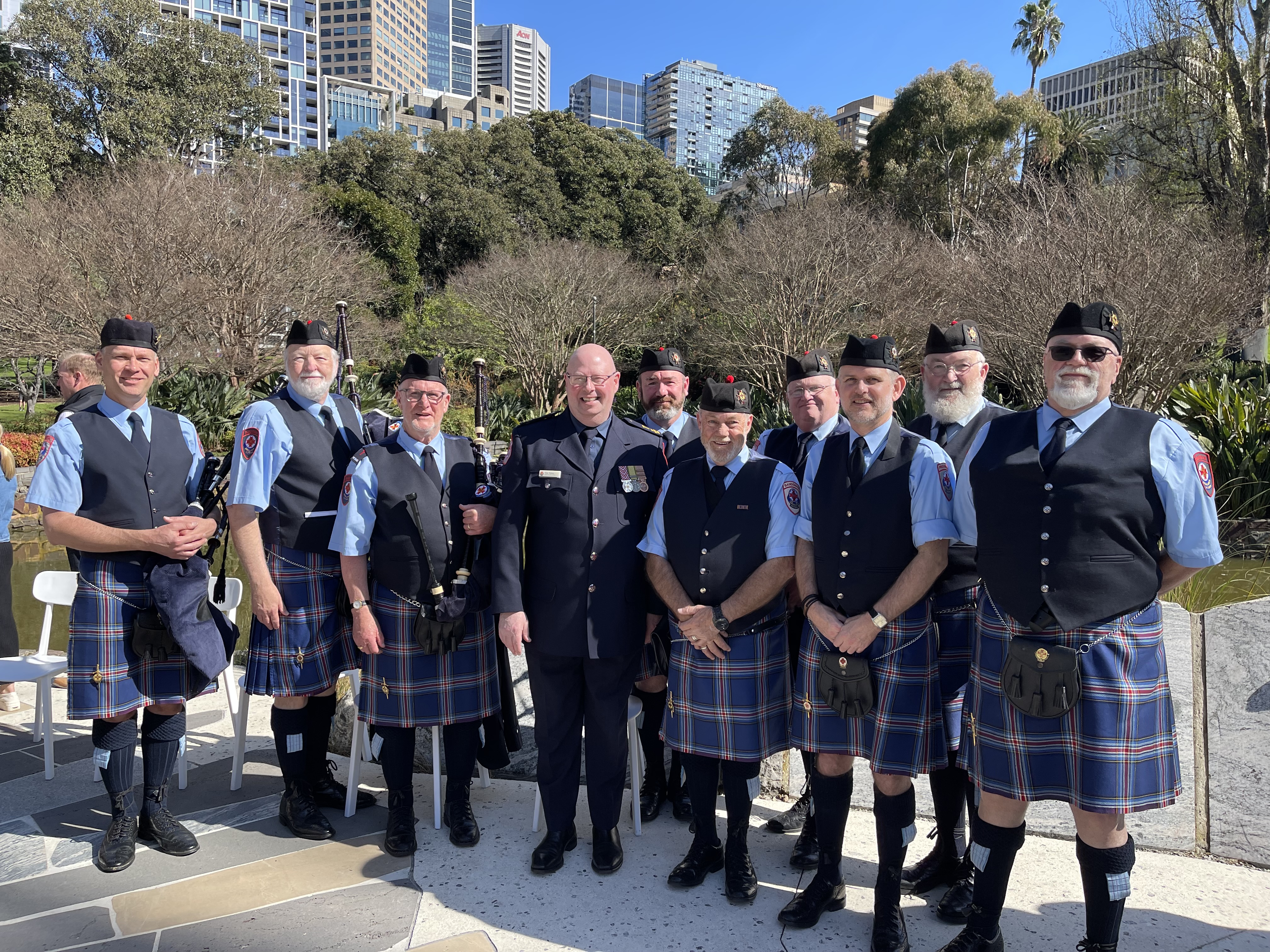Members of AV Pipes and Drums pose outside